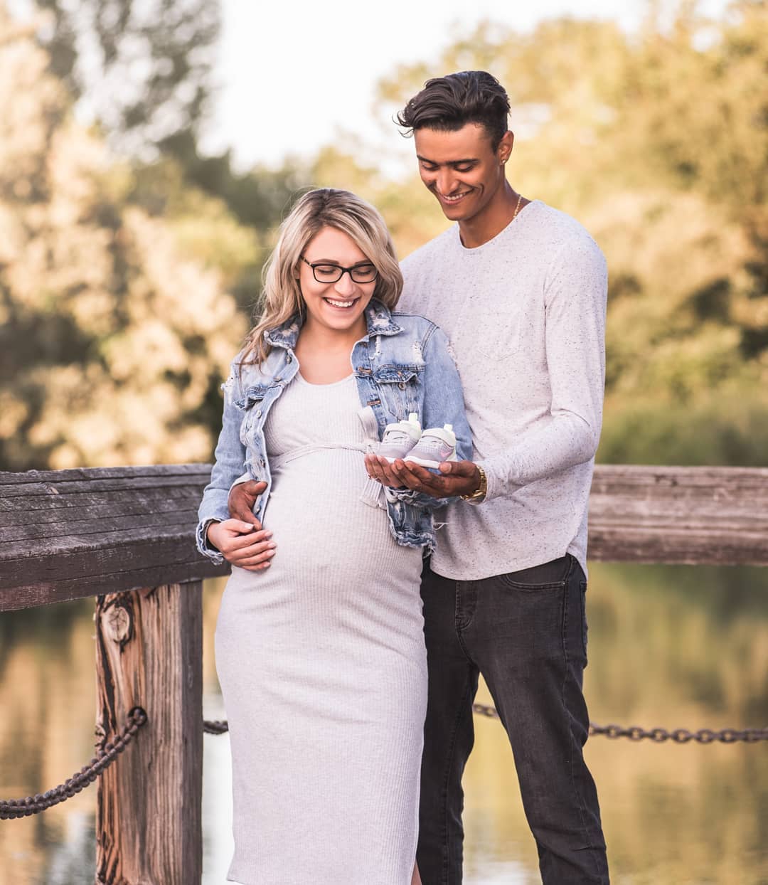 Warm sunset pregnancy photoshoot Toronto featuring an expecting couple during an outdoor maternity session